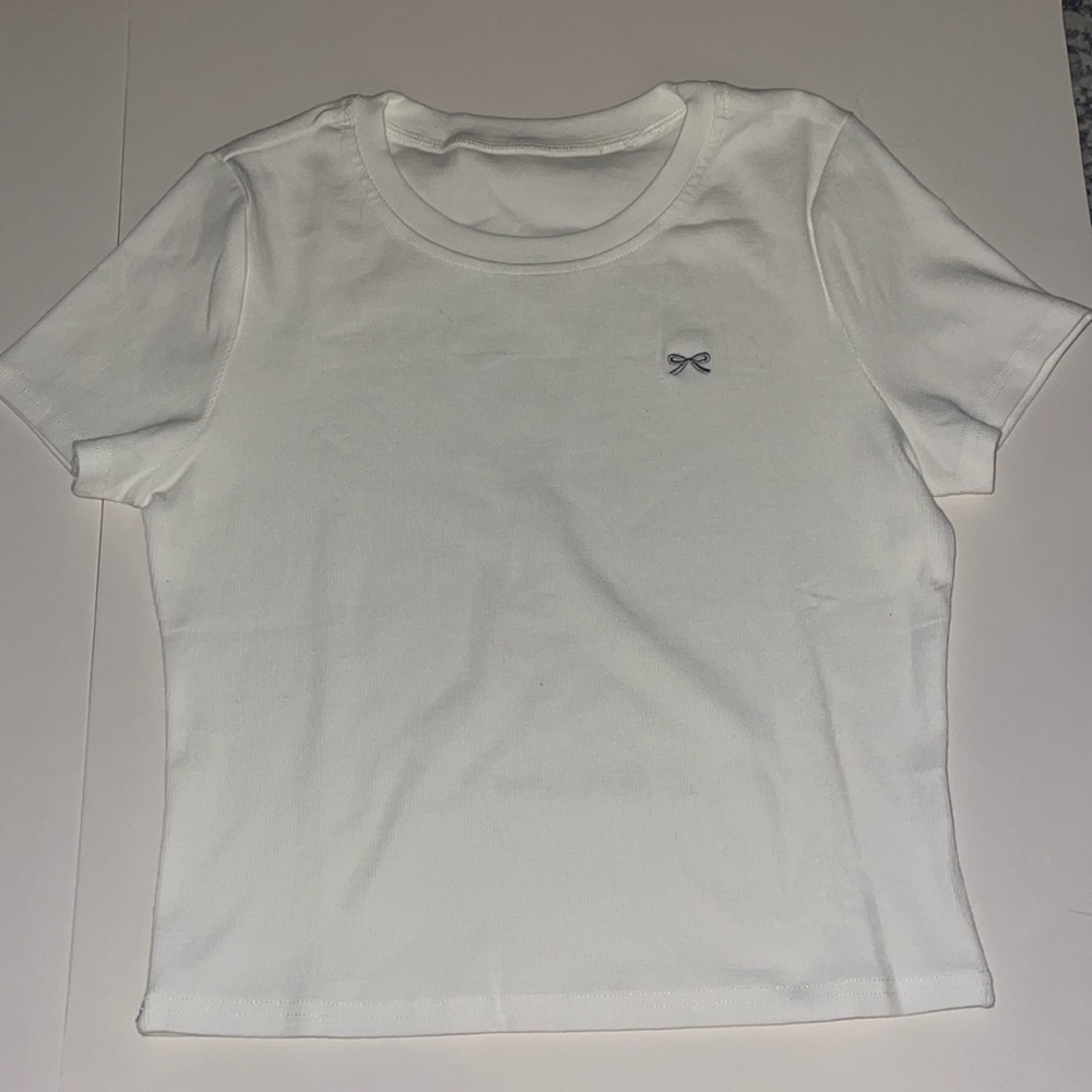 White shirt with little bow decal.
